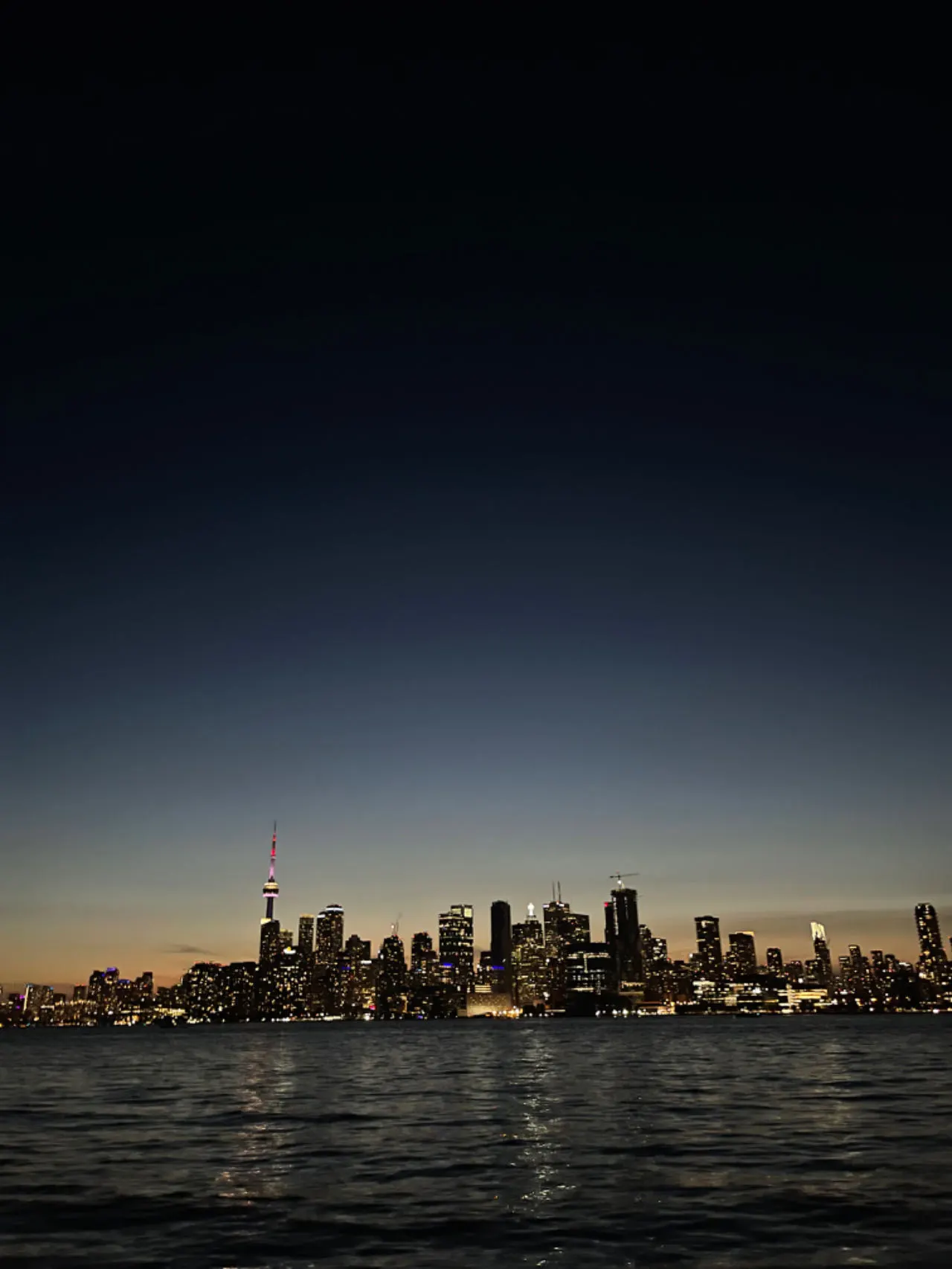 Toronto skyline at dusk, seen from the water