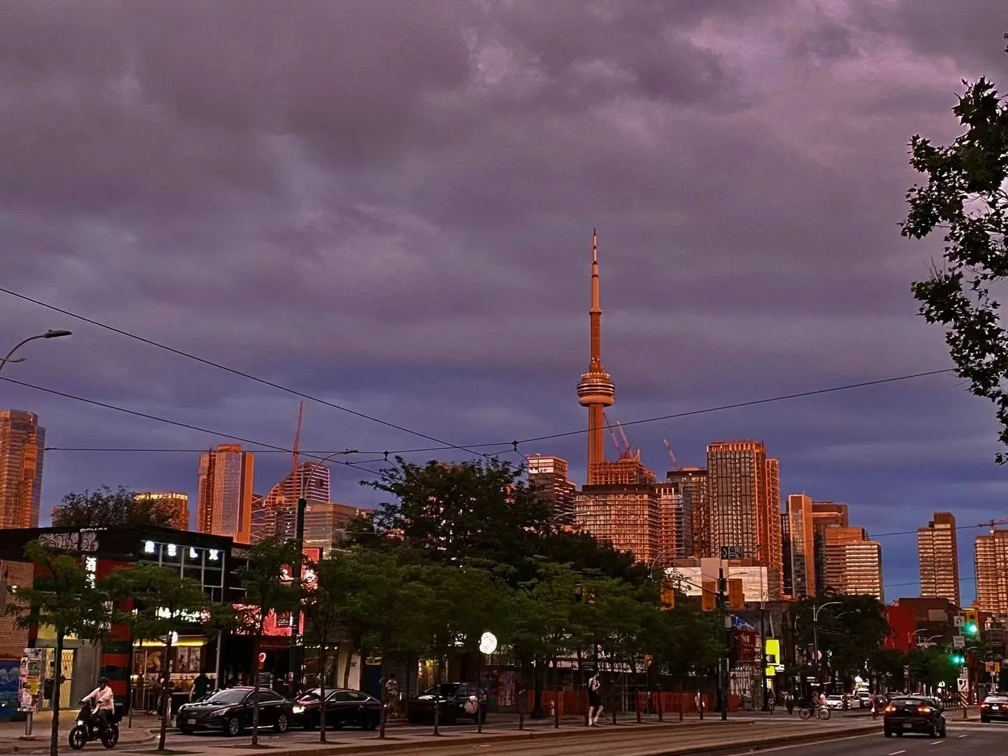 The CN Tower under a purple storm sky