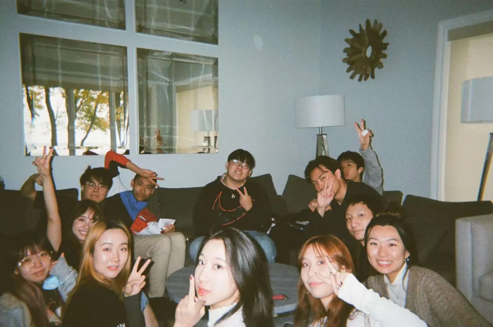 A crowd of friends squeezed onto a couch