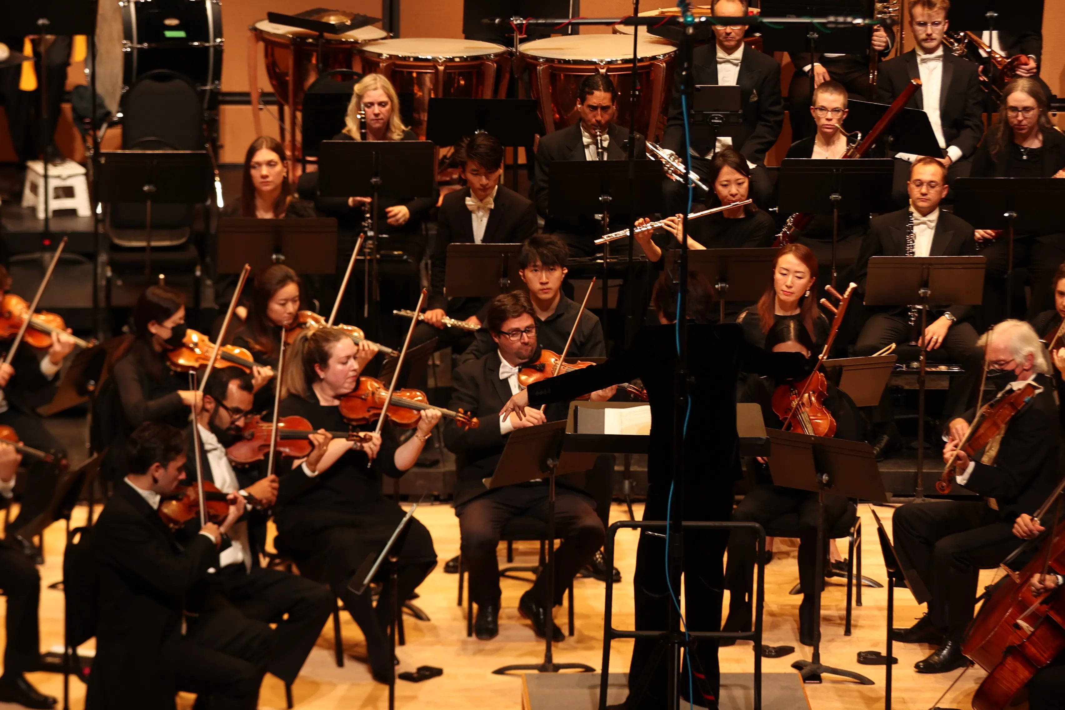 An orchestra performing on stage