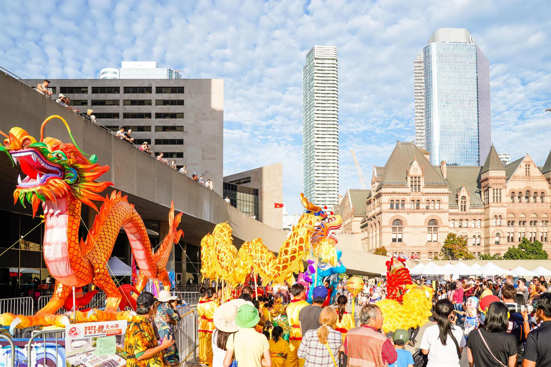 A dragon float in the festival square with the city behind