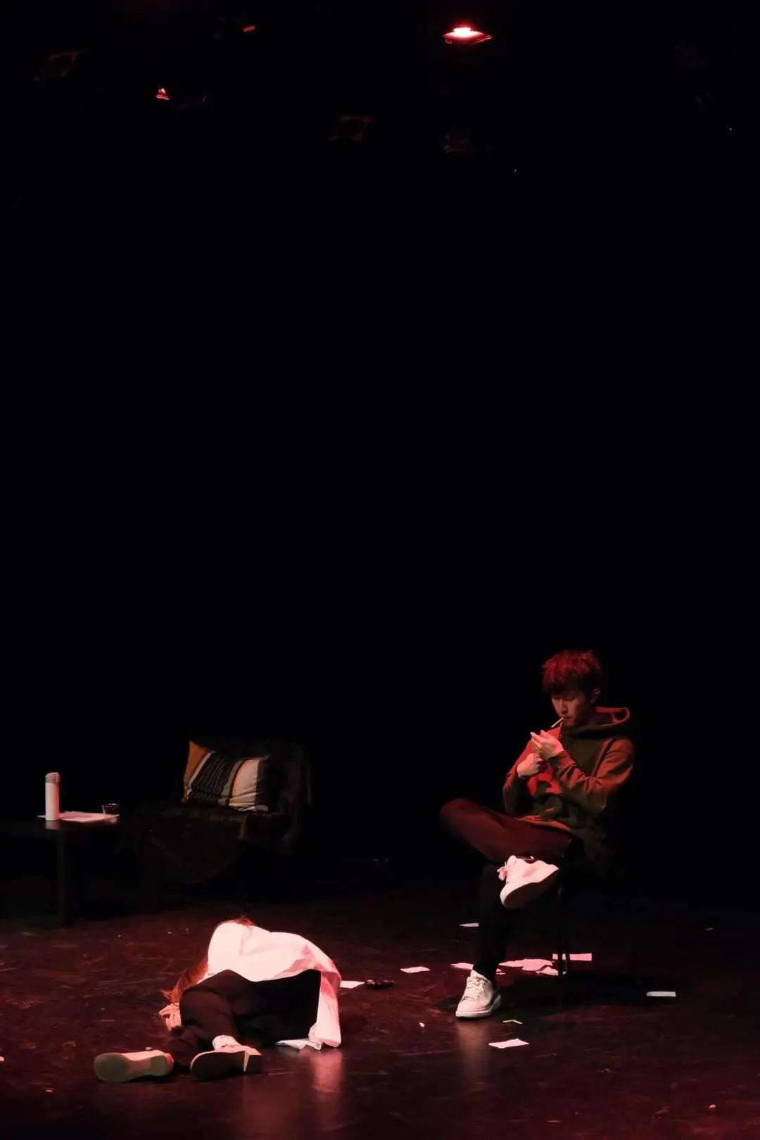 A dimly lit scene on stage